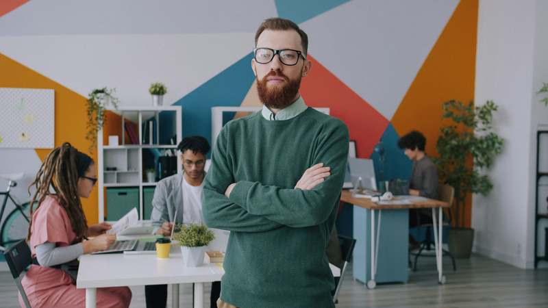 Diverse small business owner smiling while reviewing financial dashboard on tablet